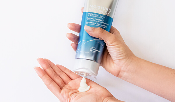Moisture-Recovery-treatment-balm-in-hand Joico conditioner being poured into hand